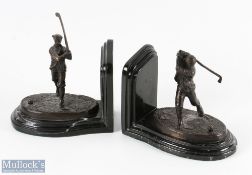 Pair of early bronze golfing bookends - each with a Victorian golfing figure on naturalistic oval