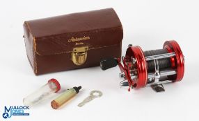 ABU Ambassadeur 6000 Multiplier Reel in red with black counterbalance handle, sliding line guide,