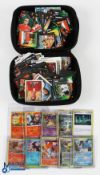 A case of various Pokemon cards & football stickers. Unsorted and worth inspecting