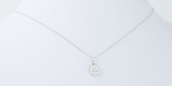 A platinum circular design pendant set with 0.50 carats of round brilliant cut diamonds on a 18