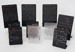 A large quantity of silver stud earrings on stands to include crystal set, pearl set, etc.