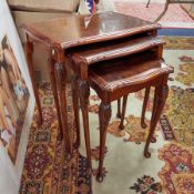 Nest of three walnut tables.
