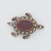 A Victorian articulated 'turtle' brooch set with old rough cut diamonds and a central cabochon cut