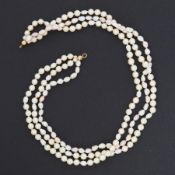 A triple row of pearls of varying shapes and colours from cream to pink, approx. 16