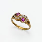 An 18ct diamond and ruby swirl ring, size J.