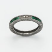 A 14ct white gold diamond and emerald half eternity ring, size N.