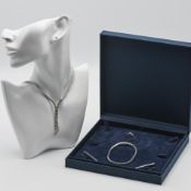 A four piece 18ct white gold suite of jewellery to include a three stone diamond ring, total diamond