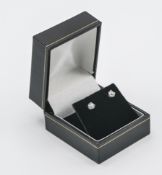A pair of 18ct yellow & white gold studs set with a round brilliant cut diamond, total diamond