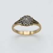 An 18ct yellow gold and diamond cluster ring, centre diamond round old cut diamond approx 0.70ct,