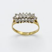 An 18ct yellow gold and diamond oblong ring, three rows of diamonds in claw setting, nineteen
