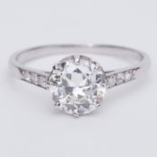 An Art Deco platinum ring (no hallmark) set with a central older round cut diamond