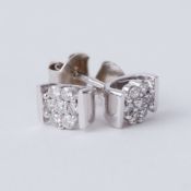 A pair of 9ct white gold flower studs set with round brilliant cut diamonds