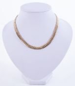 A 9ct yellow gold flat ‘herringbone’ style collar necklace