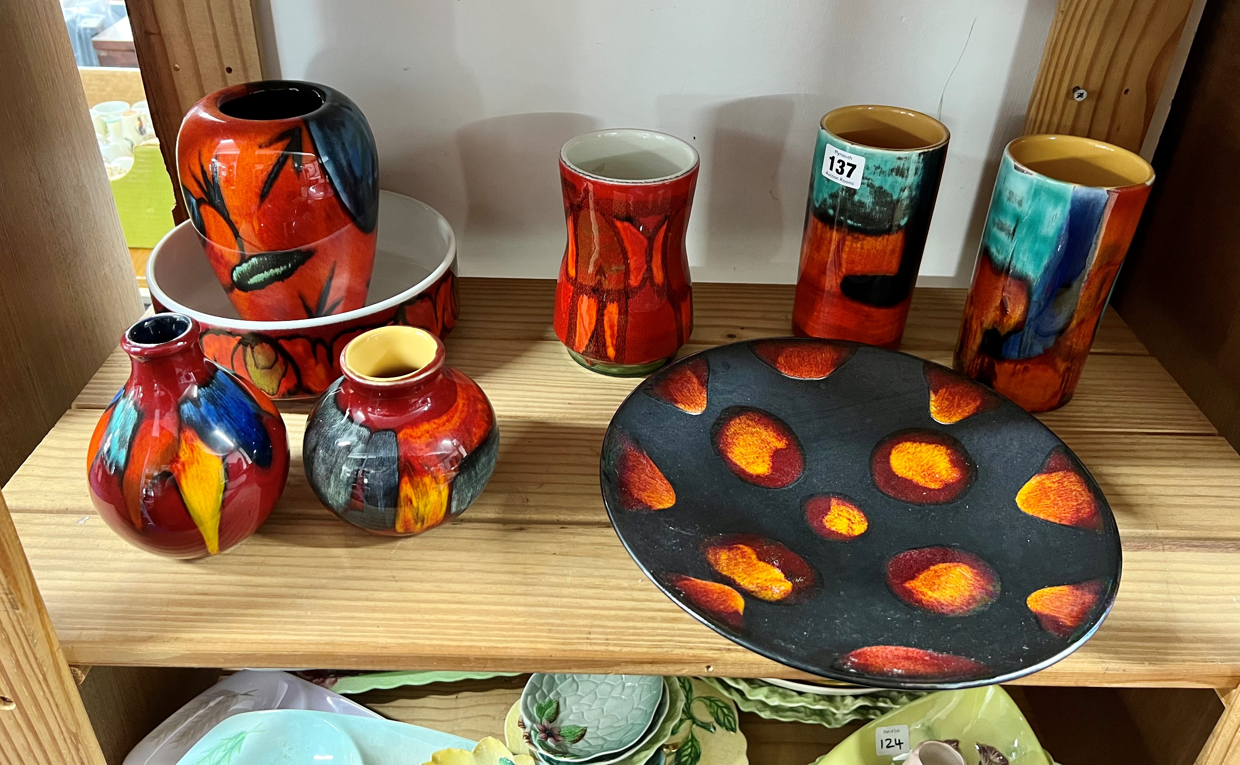 A collection of eight pieces of Poole Pottery including pair of vases, plate etc.