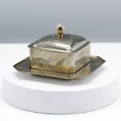 A Chinese Export silver butter dish, cover and stand, of canted square section, incised around the