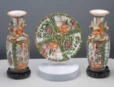 A pair of small Canton ‘famille-rose’ vases, circa 1900, each of baluster form and decorated
