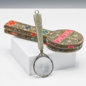 A silver-mounted magnifying glass with a carved jade handle, 19th century. The handle carved and