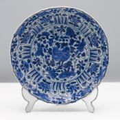 A barbed blue and white saucer dish, Kangxi (1662-1722) Decorated in the centre with blossoming