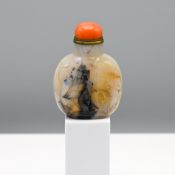 A carved agate snuff bottle, Qing dynasty Finely carved on one side in relief using the inclusions