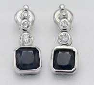 A pair of 18k white gold diamond and sapphire drop earrings, marked on both K18 0.175.
