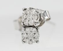 A pair of 9ct white gold diamond cluster studs.
