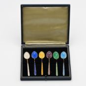 A cased set of six silver and coloured enamelled tea spoons.