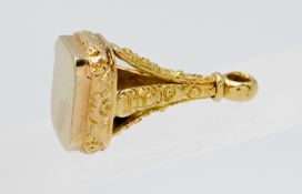 A yellow metal and ornate fob, 9.20g.