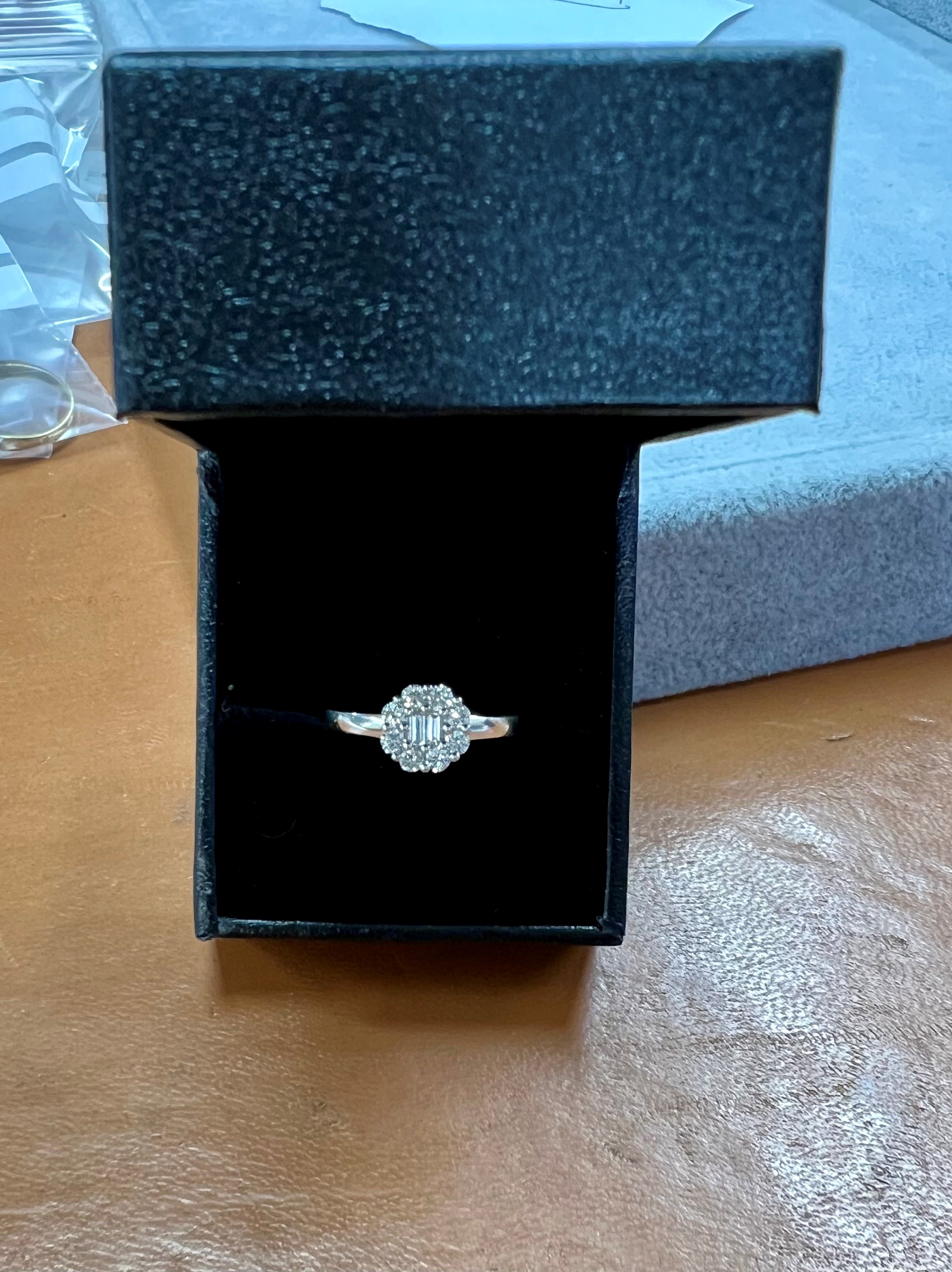 An 18ct white gold diamond cluster ring, size L.