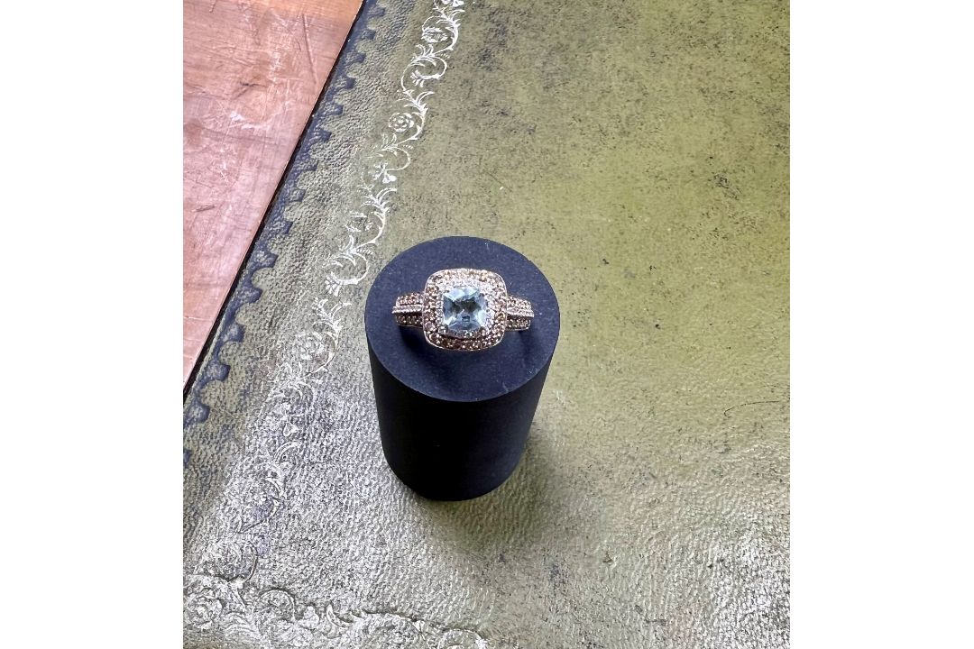 A 14ct white gold diamond and aquamarine cluster ring, size P.