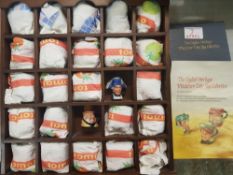 English Heritage miniature character jug collection in display case.