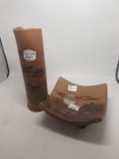 Two pieces of studio pottery to include a vase and a footed bowl, both with stylised rural scenes,