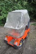 A CLASSIC 1984 VESSA TREKKA ORANGE MOBILITY SCOOTER, with rain cover and charger (untested) (
