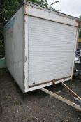 A LARGE TWIN AXLE BOX VAN TRAILER, with a roller at each end, length 306cm x 202cm wide x height