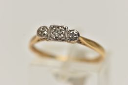 A YELLOW AND WHITE METAL THREE STONE DIAMOND RING, three small single cut diamonds illusion set in a