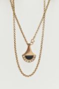 A 9CT YELLOW GOLD DIAMOND AND ONXY PENDANT WITH CHAIN, the abstract design pendant set with an