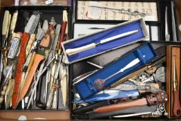 A BOX OF NOVELTY, COMMEMORATIVE AND SOUVENIR LETTER OPENERS IN TREEN, CERAMIC, ASSORTED METALS, some