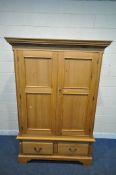 A MODERN PINE DOUBLE DOOR WARDROBE, with two drawers, on bracket feet, width 137cm x depth 66cm x