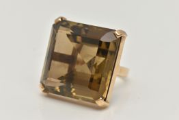 A 9CT GOLD SMOKY QUARTZ RING, designed as a large square smoky quartz within a four claw setting,
