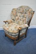 A 20TH CENTURY OAK FRAMED ARMCHAIR, with floral upholstery, width 83cm x depth 85cm x height 88cm (