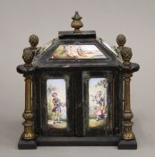 A 19th century Viennese enamel decorated ebonised miniature table cabinet. 12 cm high.