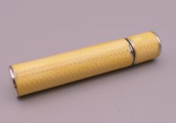 A 900 silver and yellow enamel manicure set. 7 cm high.