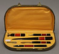 A boxed Art Deco desk set. The desk 26 cm wide.