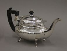 A silver teapot. 29 cm long. 18.3 troy ounces total weight.