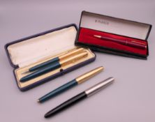Three Parker fountain pens, one with 14 ct gold nib, and two pencils.