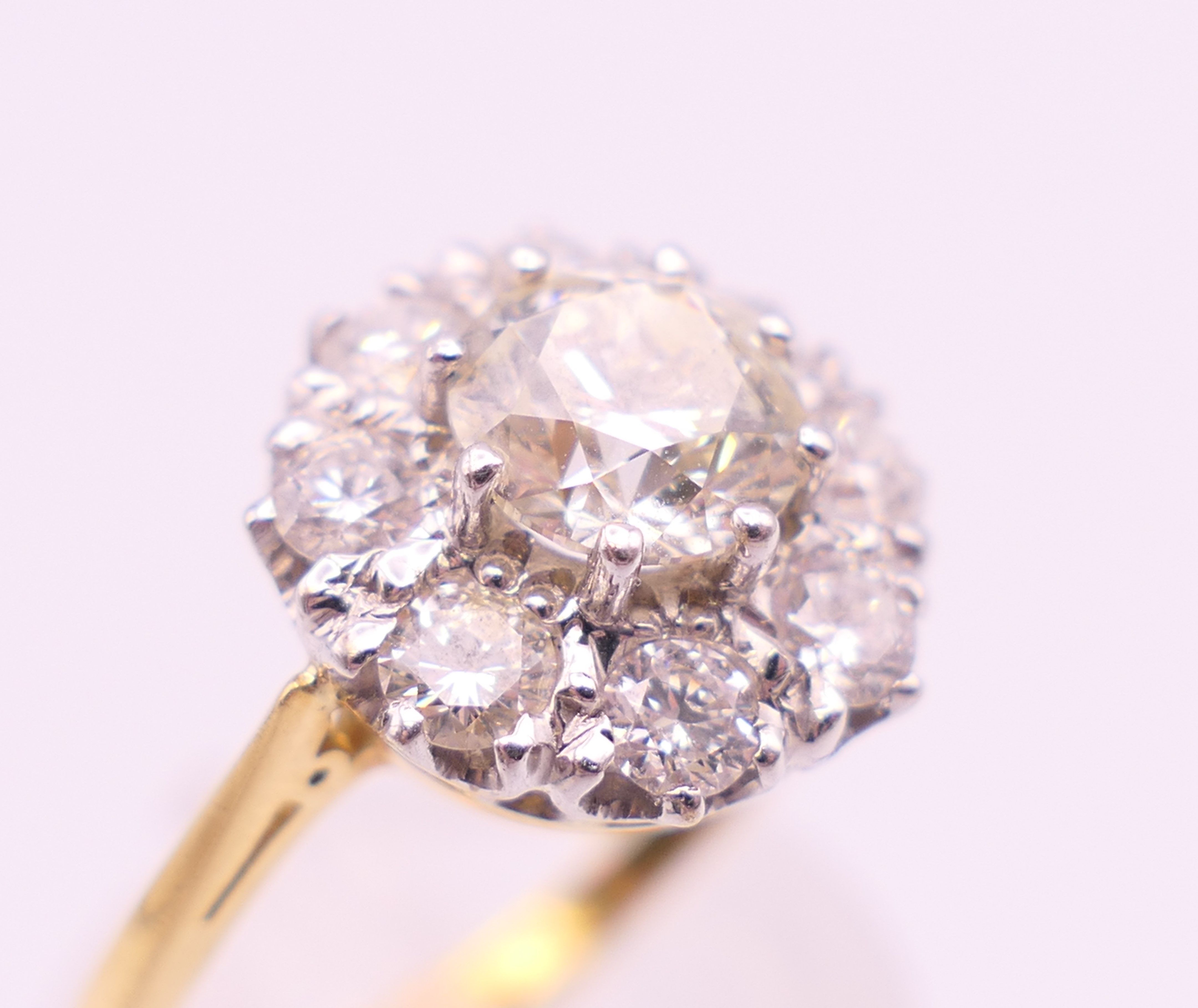An 18 ct gold and diamond flowerhead ring. Total diamond weight approximately 1.85 carats. - Image 4 of 7
