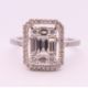 An 18 ct white gold ring with 5 baguette cut diamonds surrounded by numerous brilliant cut diamonds. - Image 2 of 8