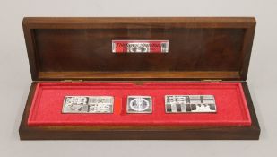 A boxed set of The Queens Silver Jubilee Standards and a Queen Elizabeth II 90th Birthday crown.