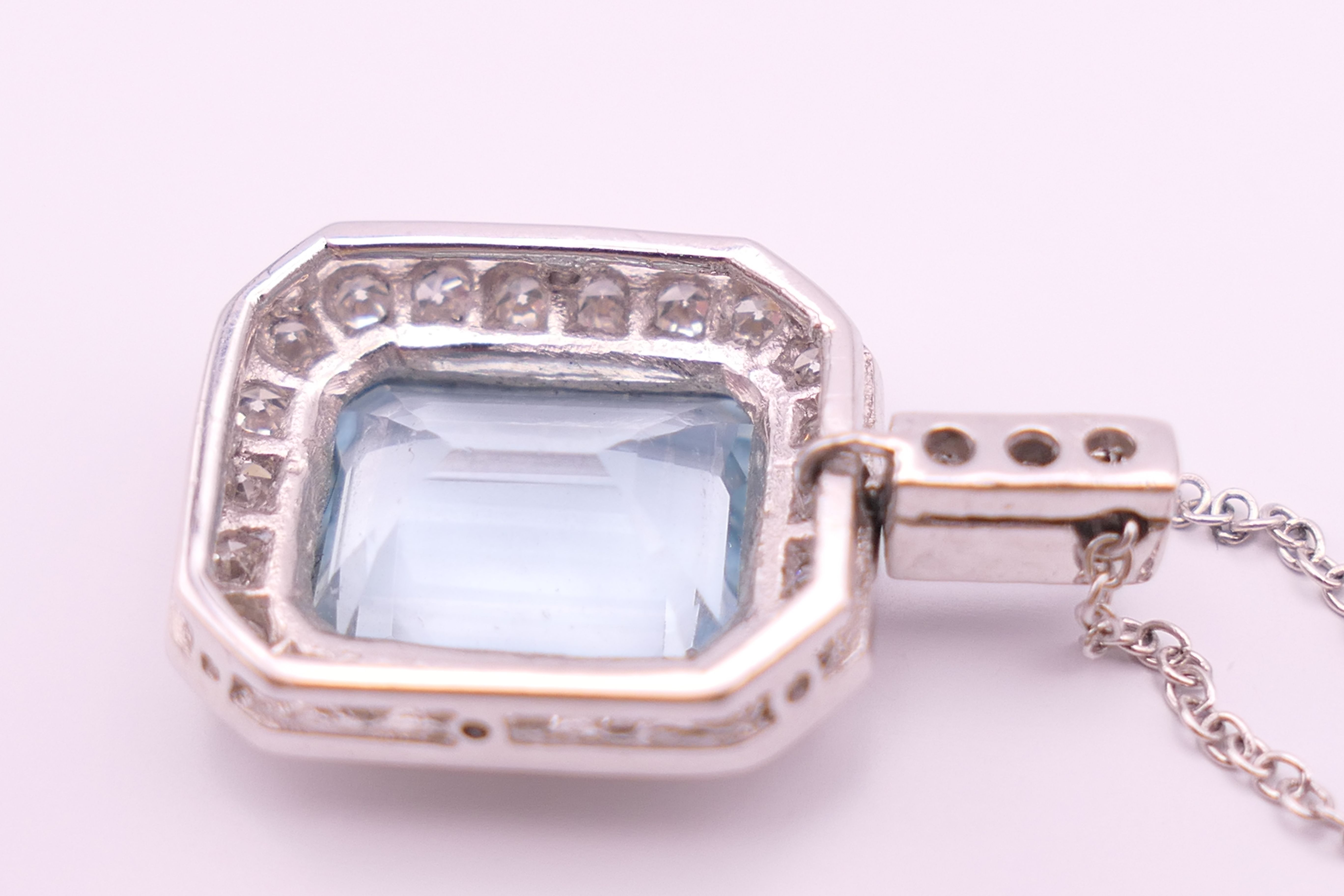 An 18 ct white gold emerald cut aquamarine and diamonds pendant on chain. - Image 4 of 6