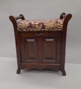 An Edwardian upholstered piano stool. 56 cm wide.