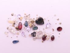 A quantity of various gemstones, including diamonds, sapphires, etc.